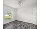 Bedroom featuring hardwood floors, natural light, and a ceiling fan at 15430 Oakcrest Cir, Brooksville, FL 34604