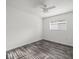 Neutral bedroom featuring gray plank floors at 15430 Oakcrest Cir, Brooksville, FL 34604