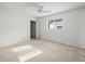 Cozy bedroom with carpet, fan, and natural light at 15430 Oakcrest Cir, Brooksville, FL 34604