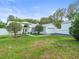 Exterior shot of gorgeous single Gathering home, lawn and garages, surrounded by mature trees at 15430 Oakcrest Cir, Brooksville, FL 34604