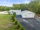 Stunning single Gathering home with attached and detached garages, lush lawn, and white perimeter fence at 15430 Oakcrest Cir, Brooksville, FL 34604