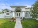 Close up of stunning front door, plants, sidewalk and exterior architecture at 15430 Oakcrest Cir, Brooksville, FL 34604