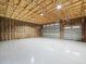 Spacious garage with insulated walls, high ceiling, and roll-up doors at 15430 Oakcrest Cir, Brooksville, FL 34604