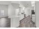 Modern kitchen with white cabinets, stainless appliances, and wood-look floors at 15430 Oakcrest Cir, Brooksville, FL 34604