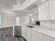 Bright kitchen featuring quartz counters, stainless appliances, an open plan, and a fireplace at 15430 Oakcrest Cir, Brooksville, FL 34604