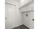 Laundry room with white cabinets for extra storage at 15430 Oakcrest Cir, Brooksville, FL 34604