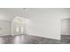 Large, bright living room with wood-look floors, vaulted ceiling and decorative double doors at 15430 Oakcrest Cir, Brooksville, FL 34604