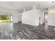 Large living room with hardwood floors, neutral colors and large windows providing ample sunlight at 15430 Oakcrest Cir, Brooksville, FL 34604