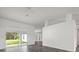 Spacious living room boasts sliding glass doors and gray wood-look flooring at 15430 Oakcrest Cir, Brooksville, FL 34604