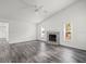 Open living area with vaulted ceiling, fan, and tile fireplace at 15430 Oakcrest Cir, Brooksville, FL 34604