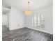 Sun-filled living room with hardwood floors, natural light and access to the outdoors at 15430 Oakcrest Cir, Brooksville, FL 34604