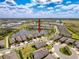 Aerial view showcases a home in a Primary-planned community with lakes, walking trails, and well-maintained landscaping at 18743 W Coastal Shore Ter, Land O Lakes, FL 34638
