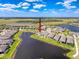 Aerial view showcasing the house in a lakeside community with ponds and lush greenery at 18743 W Coastal Shore Ter, Land O Lakes, FL 34638