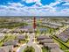 Aerial view of a waterfront property nestled in a community with lakes and manicured lawns, highlighting its prime location at 18743 W Coastal Shore Ter, Land O Lakes, FL 34638