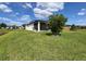 Beautiful backyard with lush lawn, mature landscaping and a screened patio at 18743 W Coastal Shore Ter, Land O Lakes, FL 34638
