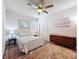 Cozy bedroom with neutral tones, a comfortable bed, and an area rug at 18743 W Coastal Shore Ter, Land O Lakes, FL 34638