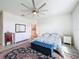 Comfortable bedroom with a plush bed, area rug, and views of an ensuite bathroom at 18743 W Coastal Shore Ter, Land O Lakes, FL 34638