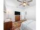 Bright bedroom with a flamingo-themed bedspread and mid-century modern furnishings at 18743 W Coastal Shore Ter, Land O Lakes, FL 34638