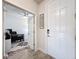 Bright foyer with white front door and view into a home office at 18743 W Coastal Shore Ter, Land O Lakes, FL 34638