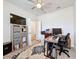View of the home office space with a ceiling fan and neutral patterned rug at 18743 W Coastal Shore Ter, Land O Lakes, FL 34638