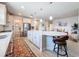 Spacious kitchen with an island, stainless steel appliances, and hardwood-style flooring at 18743 W Coastal Shore Ter, Land O Lakes, FL 34638