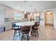 Bright kitchen featuring a large island with seating, modern appliances, and tile flooring at 18743 W Coastal Shore Ter, Land O Lakes, FL 34638