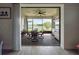 Screened outdoor patio with dining area, stainless steel grill, and tranquil lake views at 18743 W Coastal Shore Ter, Land O Lakes, FL 34638