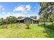 Fenced backyard with a lush green lawn and beautiful landscaping around the house at 22850 Skyview Cir, Brooksville, FL 34602