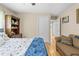 Bedroom with hardwood floors, loveseat, and hallway access at 22850 Skyview Cir, Brooksville, FL 34602