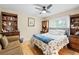 Cozy bedroom featuring hardwood floors and a comfortable floral-patterned bed at 22850 Skyview Cir, Brooksville, FL 34602