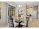 Inviting dining area with a glass table, stylish chairs, and natural light from the sliding glass door at 22850 Skyview Cir, Brooksville, FL 34602
