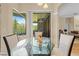 Bright breakfast nook with sliding glass doors leading to the outdoor patio and views of the backyard at 22850 Skyview Cir, Brooksville, FL 34602