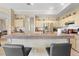 Kitchen bar with stools, stainless steel refrigerator, and tile floors at 22850 Skyview Cir, Brooksville, FL 34602