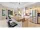 Kitchen bar with stools, sink, microwave, and fridge at 22850 Skyview Cir, Brooksville, FL 34602