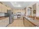 Well-lit kitchen with stainless steel appliances, tile flooring, and lots of cabinet space at 22850 Skyview Cir, Brooksville, FL 34602