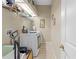 Well-equipped laundry room featuring a washer, dryer, storage shelves, and tiled flooring at 22850 Skyview Cir, Brooksville, FL 34602