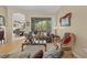 Cozy living room features a decorative sofa, area rug and large windows overlooking a green yard at 22850 Skyview Cir, Brooksville, FL 34602