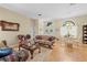 Comfortable living room boasting hardwood floors, furniture and double door access to the front yard at 22850 Skyview Cir, Brooksville, FL 34602