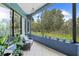 Relaxing screened patio featuring tile floors, comfortable furniture, and a view of the lush backyard at 22850 Skyview Cir, Brooksville, FL 34602