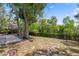 Expansive backyard featuring a cozy gazebo and mature trees, offering ample space for outdoor activities and relaxation at 2295 Rio Cir, Spring Hill, FL 34608