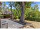 Landscaped backyard featuring a charming gazebo, a paved patio, and mature trees, offering a serene outdoor retreat at 2295 Rio Cir, Spring Hill, FL 34608