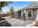 Backyard featuring a covered patio with a ceiling fan and a stone patio, perfect for outdoor entertaining at 2295 Rio Cir, Spring Hill, FL 34608