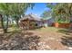 Backyard featuring a charming gazebo and the home's exterior, perfect for enjoying outdoor living and entertaining at 2295 Rio Cir, Spring Hill, FL 34608