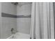 Bathtub with tiled surround and a shower curtain in a modern bathroom at 2295 Rio Cir, Spring Hill, FL 34608