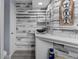 Modern bathroom with white vanity and decorative mirror on shiplap wall at 2295 Rio Cir, Spring Hill, FL 34608