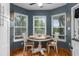 Cozy dining area features a wood table, and three windows with natural light at 2295 Rio Cir, Spring Hill, FL 34608