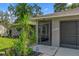 Close-up view of the home's entrance, showcasing the screened entry and well-maintained facade at 2295 Rio Cir, Spring Hill, FL 34608
