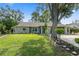 Charming single-story home featuring stone accents and a well-manicured lawn with mature landscaping at 2295 Rio Cir, Spring Hill, FL 34608