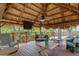 The spacious gazebo with seating, a ceiling fan, and TV, great for relaxing and entertaining outdoors at 2295 Rio Cir, Spring Hill, FL 34608