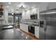 Well-lit kitchen featuring white cabinetry, black countertops, and stainless steel appliances at 2295 Rio Cir, Spring Hill, FL 34608